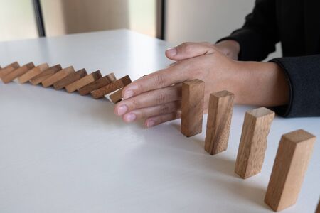 hand stop blocks wood game, gambling placing wooden block. Concept Risk of management and strategy plan, protect business to success.の写真素材