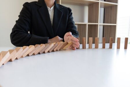 hand stop blocks wood game, gambling placing wooden block. Concept Risk of management and strategy plan, protect business to success.の写真素材