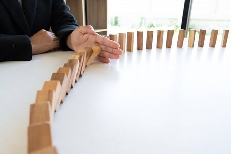 hand stop blocks wood game, gambling placing wooden block. Concept Risk of management and strategy plan, protect business to success.の写真素材