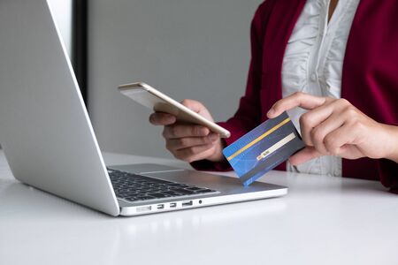 Business woman consumer holding credit card and smartphone for online shopping and payment make a purchase on the Internetの写真素材