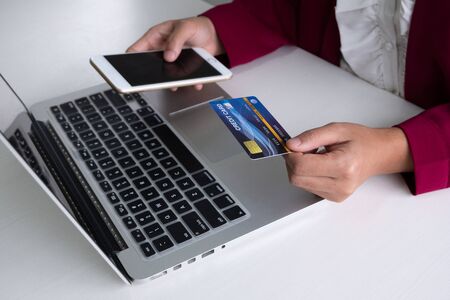 Business woman consumer holding credit card and smartphone for online shopping and payment make a purchase on the Internet.の写真素材