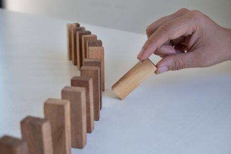 Hand pull block wood game, gambling placing wooden block. Concept Risk of management and strategy plan, protect business .の写真素材