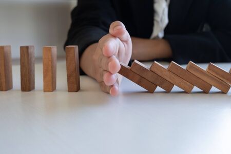 hand stop blocks wood game, gambling placing wooden block. Concept Risk of management and strategy plan, protect business to success.の写真素材