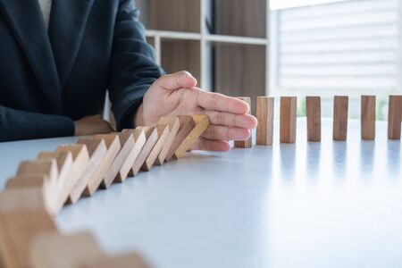 hand stop blocks wood game, gambling placing wooden block. Concept Risk of management and strategy plan, protect business to success.の写真素材