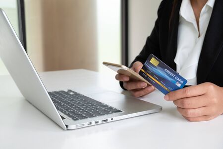 Business woman consumer holding credit card for online shopping and payment make a purchase on the Internet.の写真素材