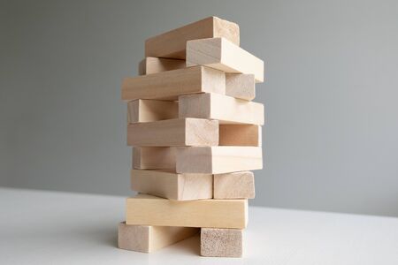 Wood block tower with architecture model, Concept Risk of management and strategy plan, growth...