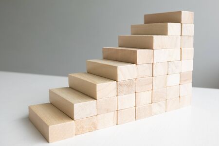 Wood block tower with architecture model, Concept Risk of management and strategy plan, growth...