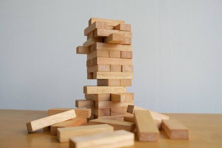 Wood block tower with architecture model, Concept Risk of management and strategy plan, growth business success process and team work.の写真素材