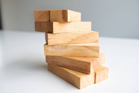 Wood block tower with architecture model, Concept Risk of management and strategy plan, growth business success process and team work.の写真素材