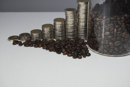 coffee bean in glass bottle with coins graph, business growth concept.の写真素材