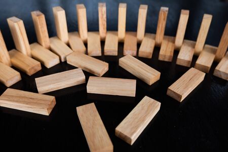 Wood block pile with architecture model with classic black tone background, Concept Risk management...