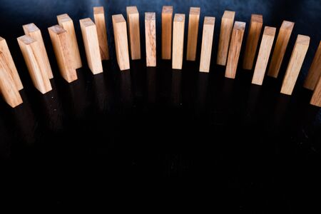 Wood block pile with architecture model with classic black tone background, Concept Risk management...
