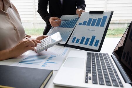 Two business leader women discussing the charts, graphs and showing the results for planning management new project.の写真素材