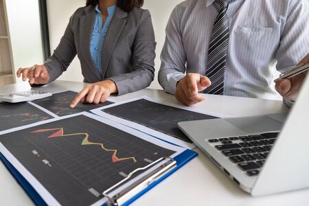 A team of business executives are planning consultations about business investments related to shares. By analyzing and calculating the stock market to find marketing profits.の写真素材