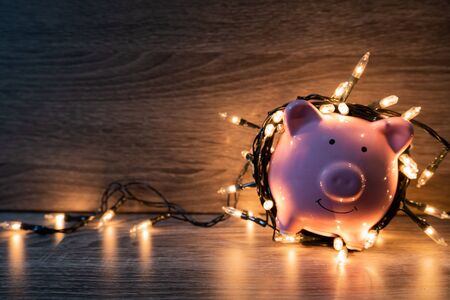 Pink piggy bank with party light, organize a party for the event where successful in saving money for use in various festivals.の写真素材