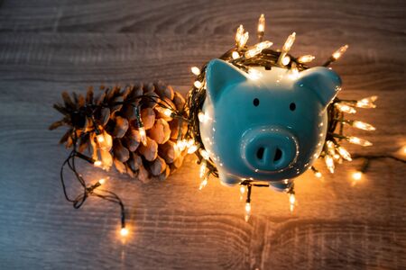 blue piggy bank with party light, planning a party for the event where successful in saving money...