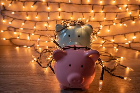 Pink and blue piggy bank with glittering lights, organize parties for successful activities to save money for retirement.の写真素材
