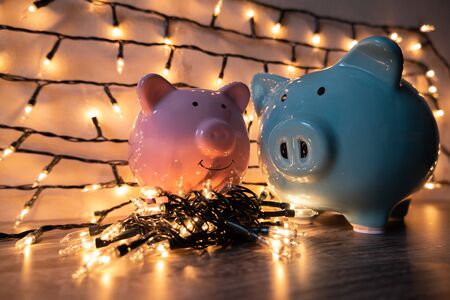 Pink and blue piggy bank with glittering lights, organize parties for successful activities to save money for retirement.の写真素材