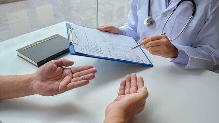 The female doctor sat on the examination of the patient's history and was ready to listen to the...
