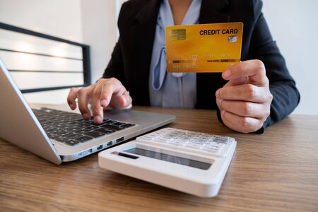 Business women use credit cards and laptops for online shopping and making payments the internet.の写真素材