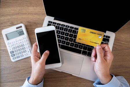 Business woman consumer holding credit card and smartphone for online shopping and payment make a purchase on the Internet.の写真素材