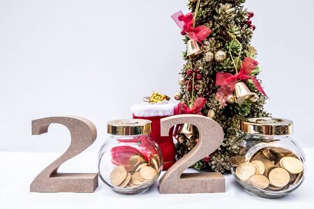 Beautifully decorated Christmas tree with a holiday party beginning in the new year and crossing to...