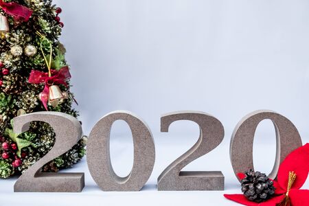 Beautifully decorated Christmas tree with a holiday party beginning in the new year and crossing to...