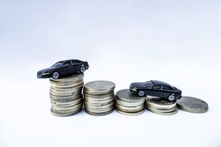 Toy cars with gold coins show To growth, saving money for car loans.の写真素材