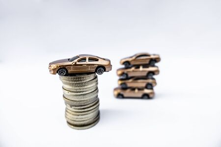 Toy cars with gold coins show To growth, saving money for car loans.