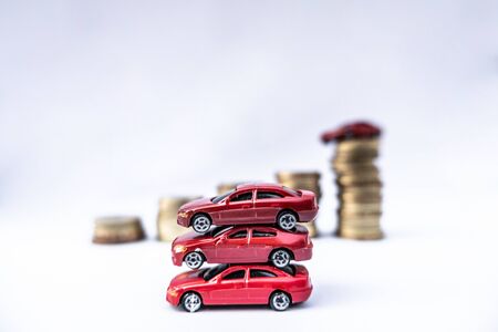 Toy cars with gold coins show To growth, saving money for car loans.の写真素材