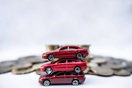 Toy cars with gold coins show To growth, saving money for car loans.の写真素材