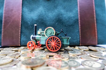 Toy cars with gold coins show To growth, saving money for car loans.の写真素材