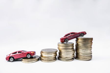 Toy cars with gold coins show To growth, saving money for car loans.の写真素材