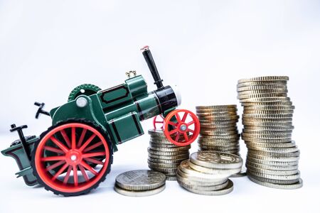 Toy cars with gold coins show To growth, saving money for car loans.の写真素材