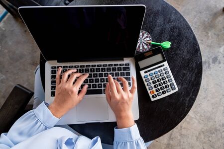Close-up Of  Young businesswomen working on laptop for online searching.の写真素材