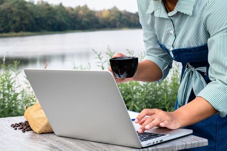 The woman inspected the coffee bean quality and recorded the results.の写真素材
