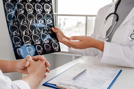 Female doctors, specialists in treatment, make an appointment to meet patients after x-ray and give advice, explain medical information and diagnose the disease. Concept of treatment and good health.の写真素材