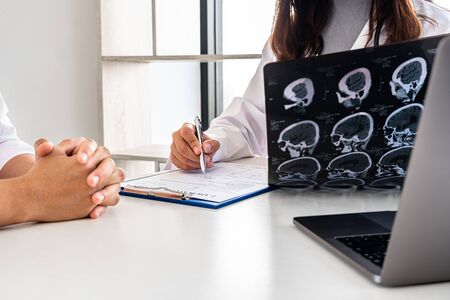 Female doctors, specialists in treatment, make an appointment to meet patients after x-ray and give...