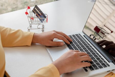 Young lady use credit cards and laptops for online shopping and making payments the internet.の写真素材