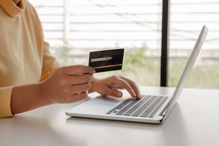 Young lady use credit cards and laptops for online shopping and making payments the internet.