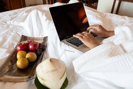 The hand of Young woman Sit play laptop In a luxurious room Ready Fruit.の写真素材