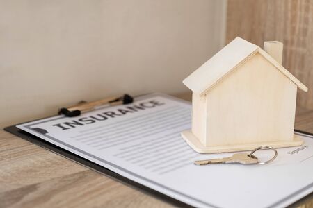 Insurance form with sample of house and keys Home insurance concept.の写真素材