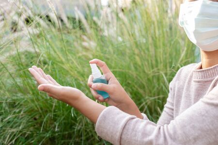Women hand use alcohol spray to prevent the spread of germs, bacteria and viruses. Measures to prevent coronavirus infection.の写真素材