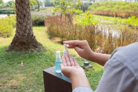 Young women hand holding a hand sanitizer to prevent virus infection Covid-19 protection device.