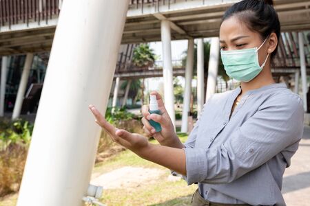 Women hand use alcohol spray to prevent the spread of germs, bacteria and viruses. Measures to prevent coronavirus infection.の写真素材