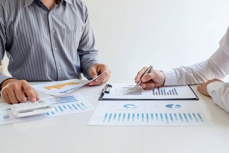 Two business leader discussing the charts and graphs showing the results, Planning to start new...