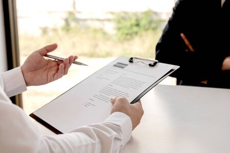 Business people hold a job profile and talk to job applicants for job interviews about careers and...