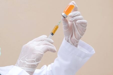 Professional doctors perform testing and analyzing samples of COVID-19 vaccines for immunization prevention and treatment from viral infections. Medical and health care concepts.の写真素材