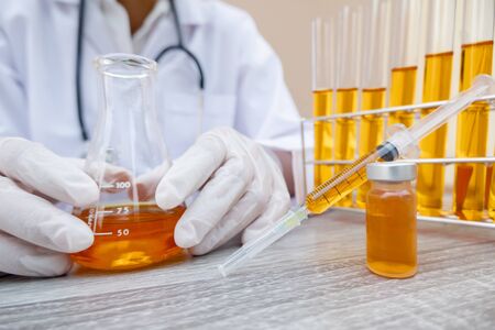 Professional doctors perform testing and analyzing samples of COVID-19 vaccines for immunization...