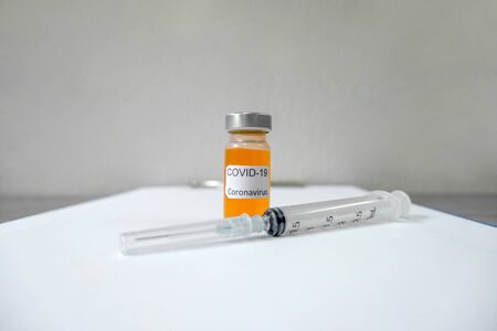 Professional doctors perform testing and analyzing samples of COVID-19 vaccines for immunization prevention and treatment from viral infections. Medical and health care concepts.の写真素材